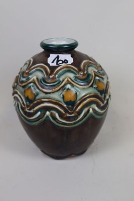 a small vase with a tag on it sitting on a table