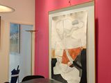a painting hanging on the wall above a dining room table