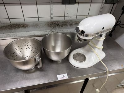 two mixers and a bowl on the counter