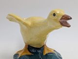 a small yellow duck sitting on top of a blue base
