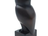 an image of a black sculpture of an owl sitting on a square base