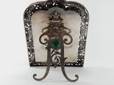 a metal frame with a green heart on it