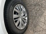 a white car that has a flat tire on the side of the road