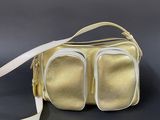 an image of a gold purse with two compartments on a black surface