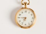 gros plan d'une montre de poche sur une surface blanche