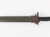 an old knife with a brown handle on a white surface