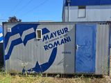 a blue and white sign on the side of a building