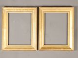pair of antique gold picture frames on grey background