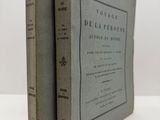 two books sitting on top of each other on a white surface