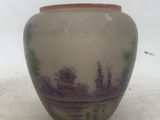 a vase that is sitting on the ground in the snow