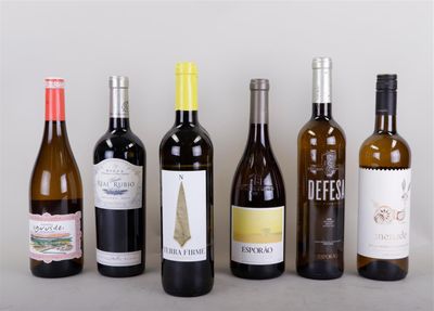 several bottles of wine are lined up on a table