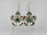 silver flower earrings with green glass beads on a clear acrylic stand
