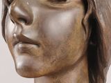bronze statue of a woman with her eyes closed and eyes closed