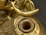 a gold statue of an elephant with a bird on it ' s head