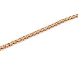 a close up of a gold chain bracelet on a white background