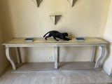 a cat that is sitting on a table in a room