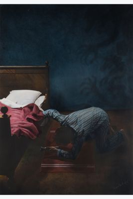 a man that is laying on a bed with a pillow