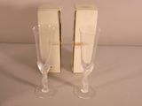 two wine glasses sitting next to each other on a table
