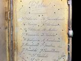 a small silver case with writing on the inside