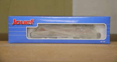 a box with a toy airplane in it sitting on a table