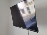 a flat screen tv mounted on the wall in a small room