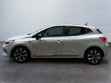 the silver car is parked in a parking lot on a cloudy day