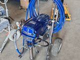 a picture of a blue airless paint sprayer in a garage