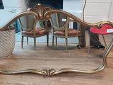 a mirror that is sitting on the floor next to a chair