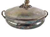 a silver plate with a bird on top of it