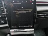 the interior of a car with a touch screen and a steering wheel