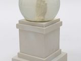 a snow globe sitting on top of a white pedestal