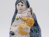 a figurine of a woman holding a child