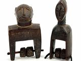 pair of carved wooden figures of a man and a woman