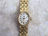 an image of a woman ' s wrist watch on a white surface