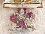 a white purse with a bunch of flowers in it