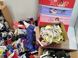 many pairs of shoes and socks in boxes on the floor