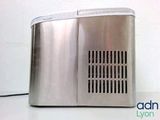 a silver toaster sitting on a table with a white wall in the background