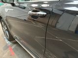a close up of a car door handle on the side of the road