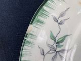 a close up of a plate with a bird on it