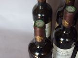several bottles of wine are lined up on a table