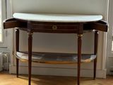 a table with a marble top on it in a room