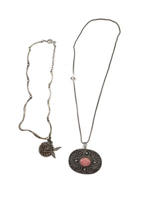 two necklaces with a pendant and a pendant with a bird on it