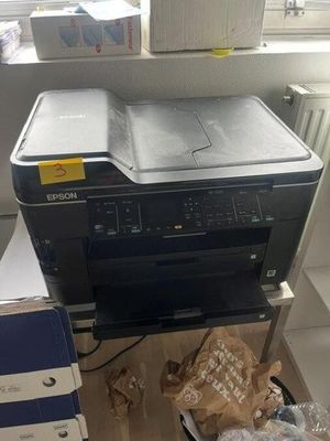 a printer sitting on top of a desk next to a box