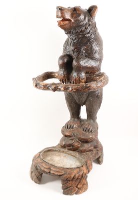 a statue of a bear that is on a stool