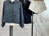 a mannequin with two shirts on it and a pair of shorts on a stand