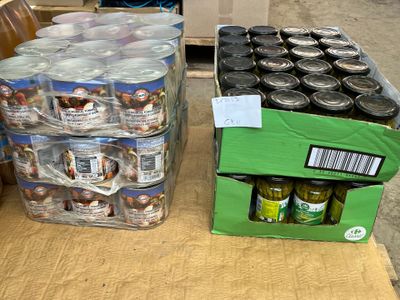 many cans of beer and cans of pickles on the table