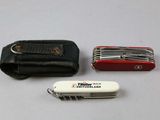 a small swiss army knife and a wallet on a table