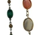 several different colored stones are arranged in a row on a white background