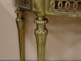 a small table with a marble top on a tile floor