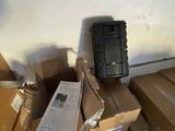 a pile of boxes and a cell phone on the floor